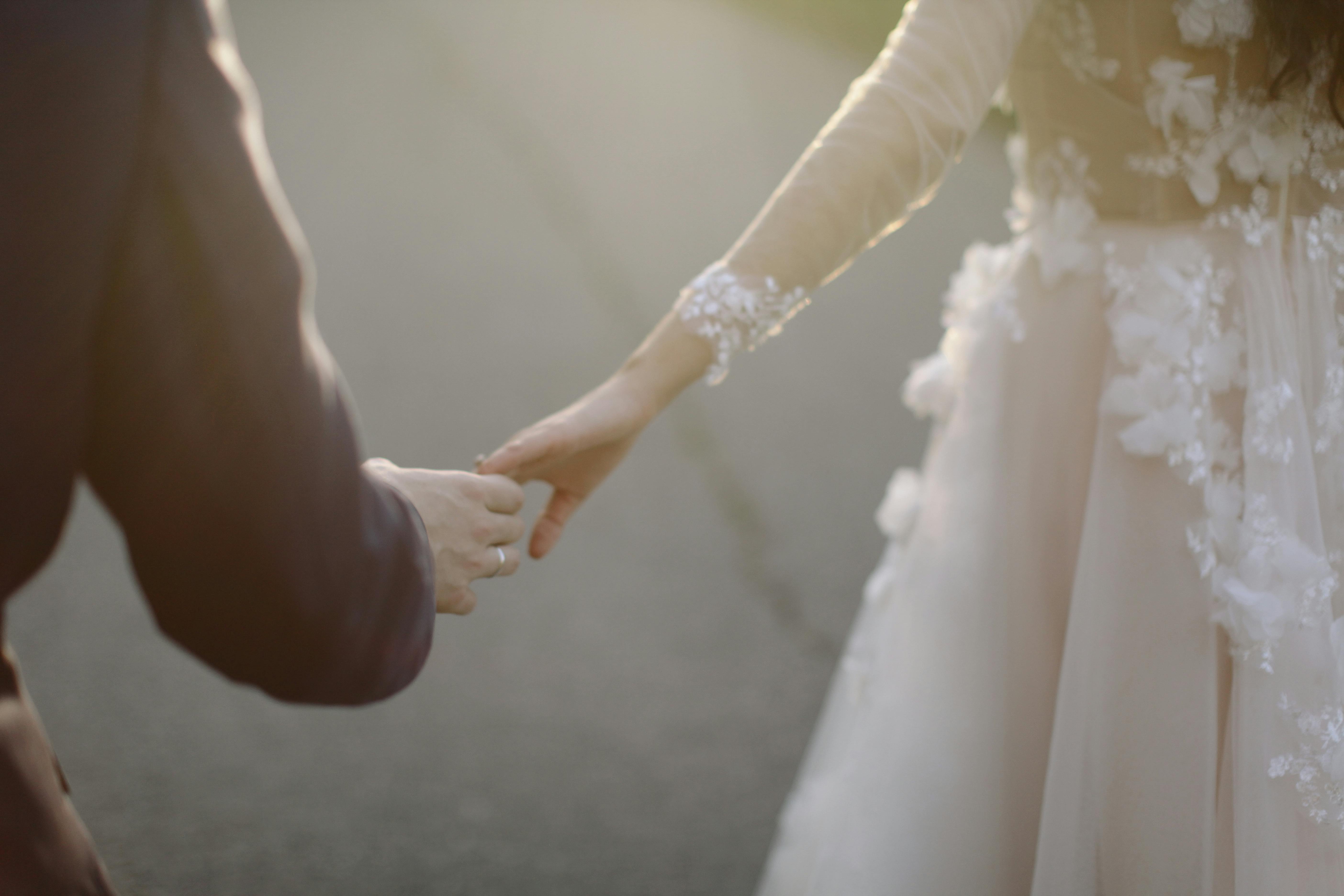 A bride and groom holding hands