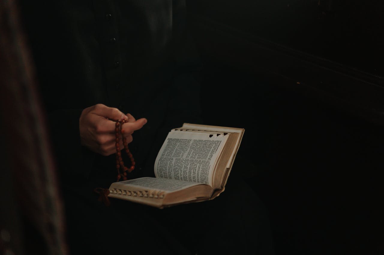 A priest holding a opened bible