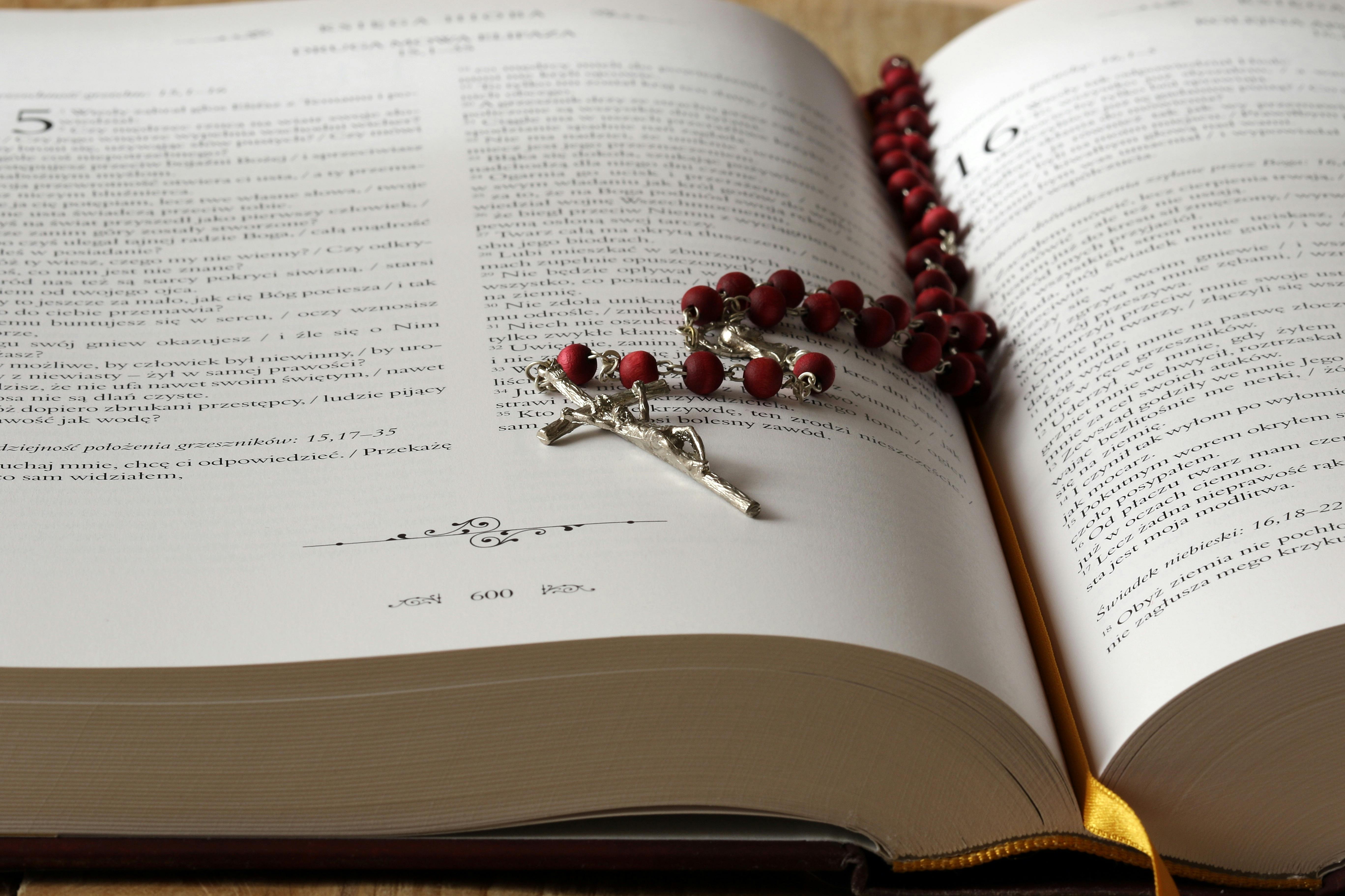 Open Bible with a rosary  resting on the pages
